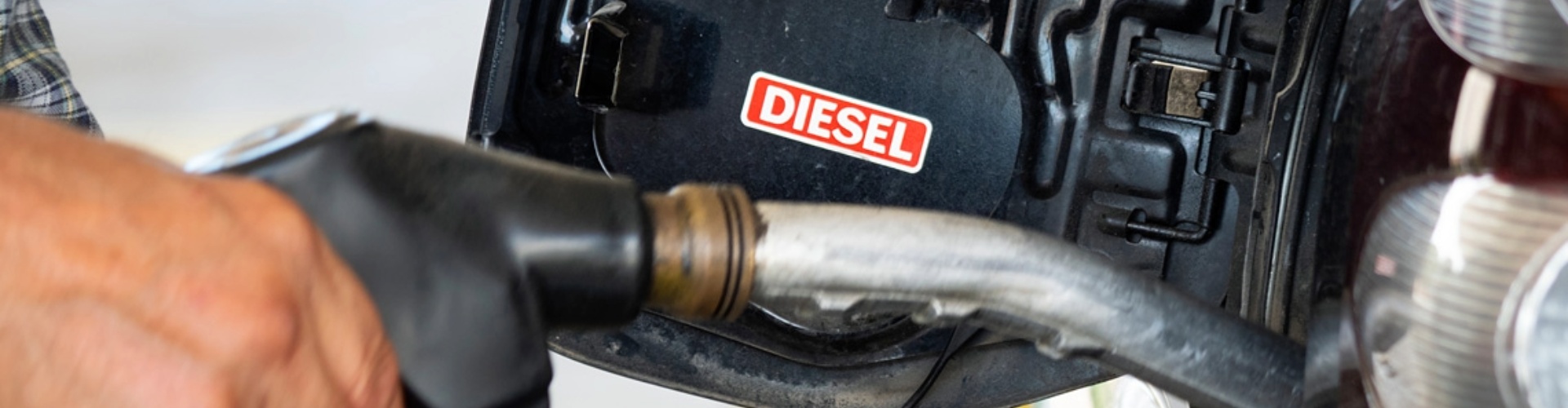 A diesel pump being inserted into a filler