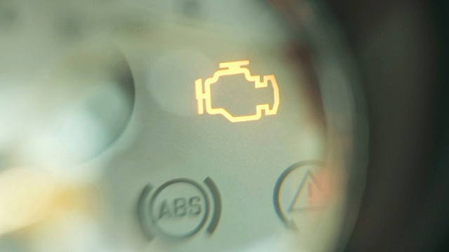 Illuminated car dashboard engine light