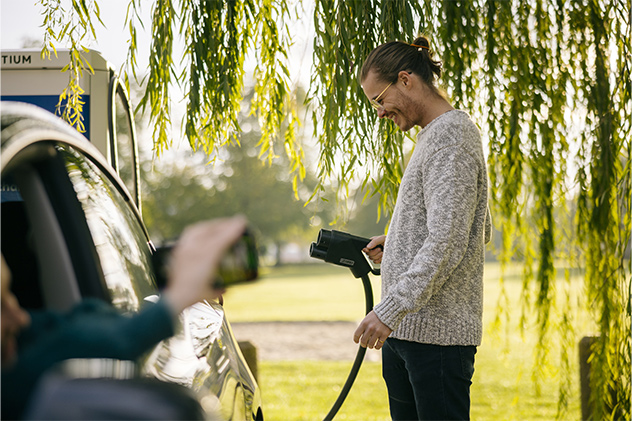 Man holding charger plug at NRMA EV charging stations