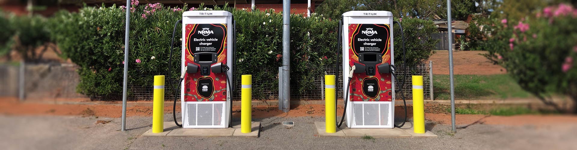 Front on view of two NRMA EV chargers with indigenous Australian designs in Wilcannia, NSW