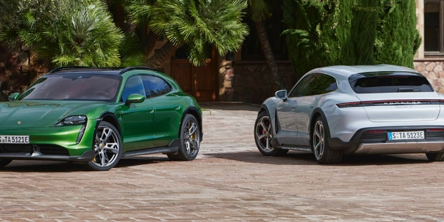 Two Porsche Taycan Cross Turismos parked beside each other.