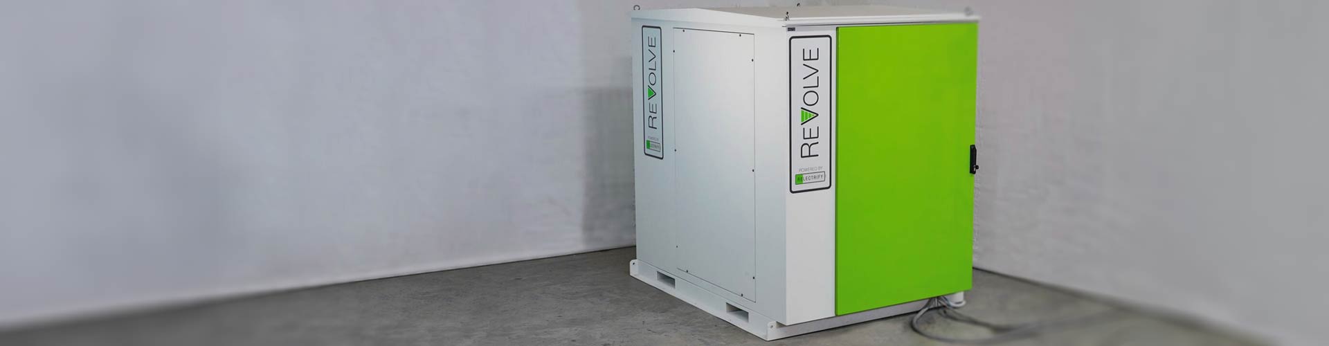 Energy storage battery pack with green and white branding placed in corner of a room