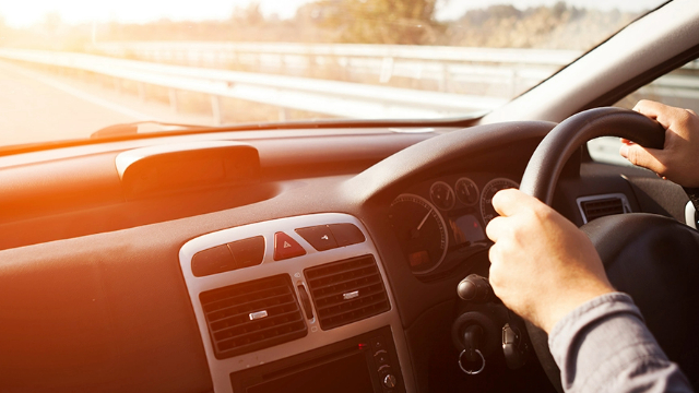 Dashboard and steering wheel on open road Dashboard and steering wheel on open road