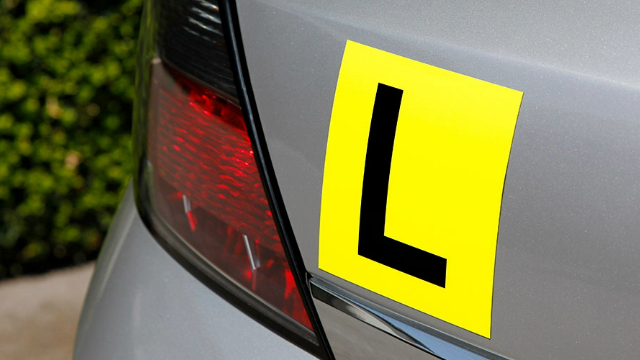 Close-up of a L-plate on the rear bumper of a car