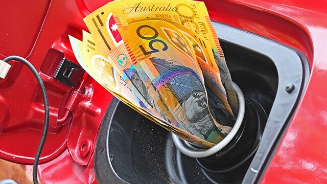 A wad of cash sticking out of a car's petrol tank filler