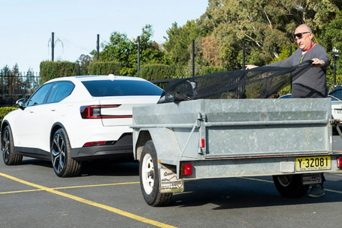 man-loads-ev-towed-trailer-1200x800 Slide 2