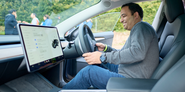 man test driving an electric vehicle