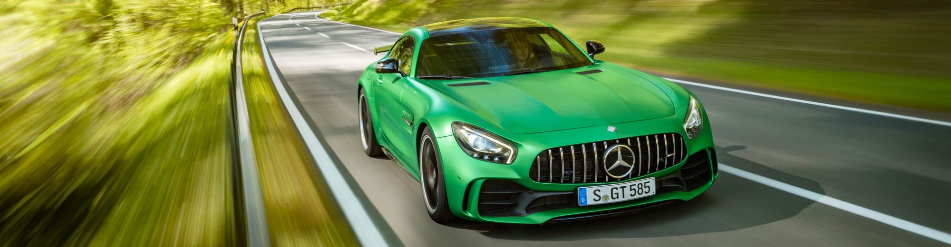 Green Mercedes-AMG GT R driving fast