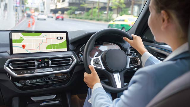 Woman driving car with navigation system showing map