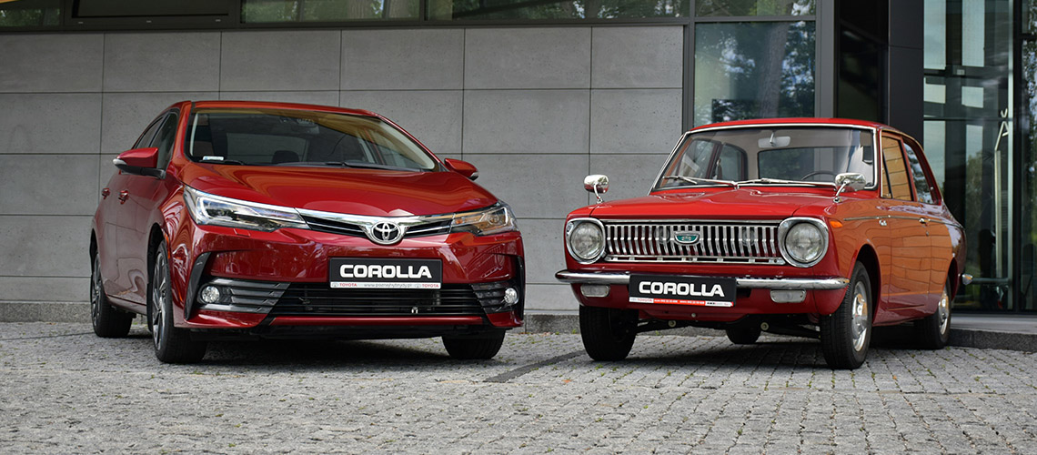 A recent-model red Toyota Corolla parked next to an early-model red Toyota Corolla A recent-model red Toyota Corolla parked next to an early-model red Toyota Corolla