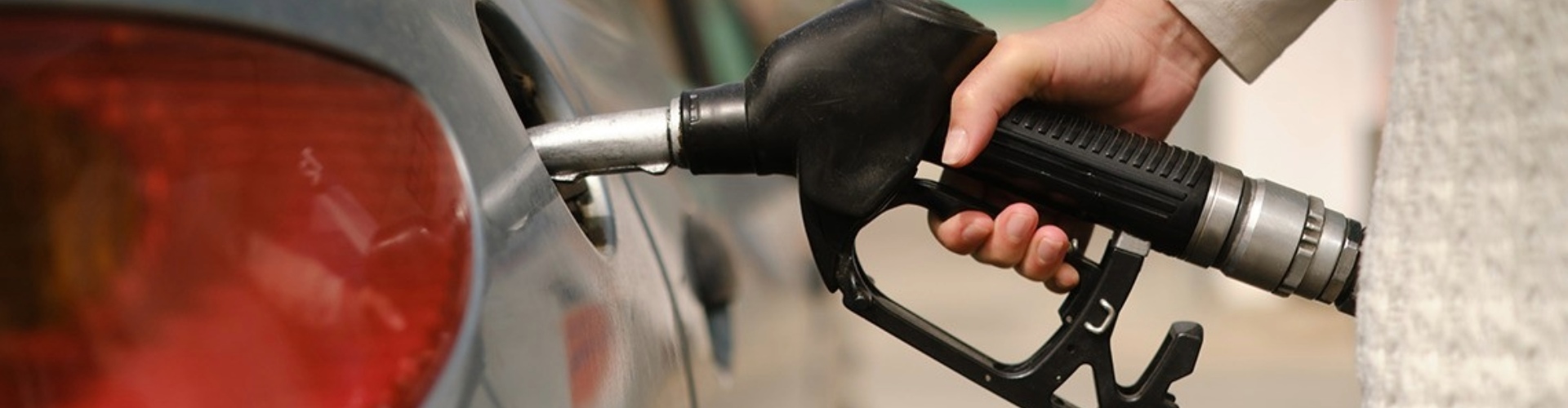 Close-up of a fuel pump being put into a car petrol filler