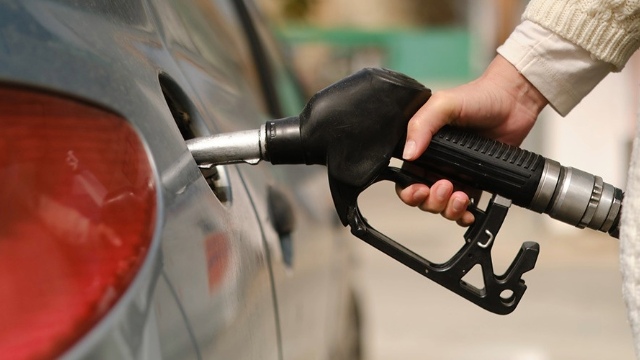 Close-up of a fuel pump being put into a car petrol filler