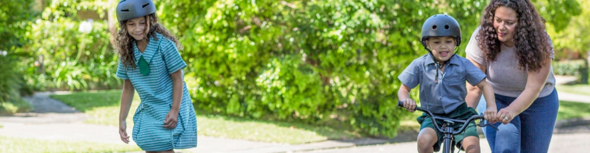A parent takes their children out for road safety lessons