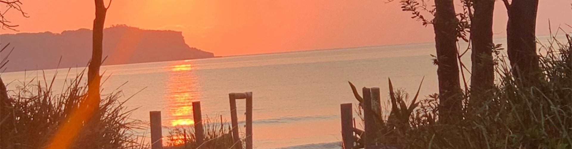 A sunset over a beach setting