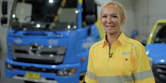 Female nrma tow truck driver standing in front of her truck