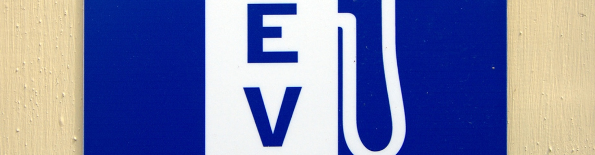 A white on blue graphic of an EV charging station