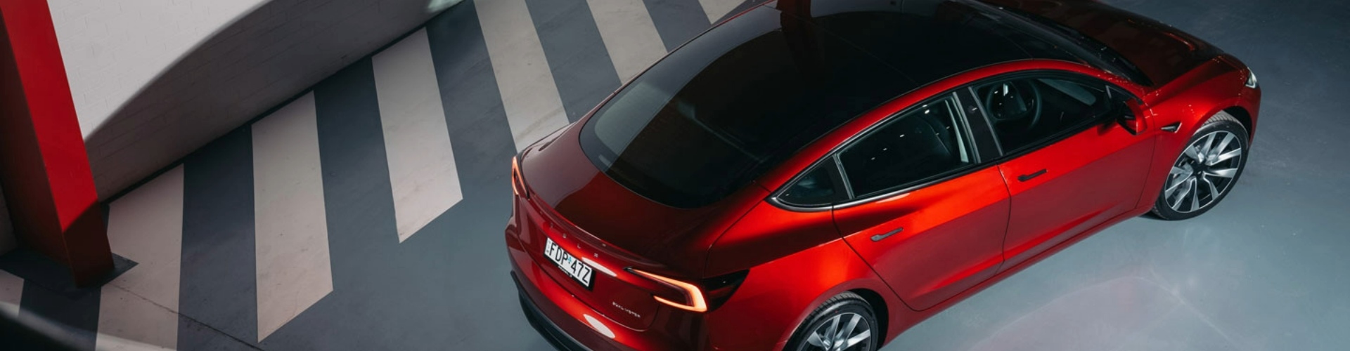 Overhead view of bright red Tesla.