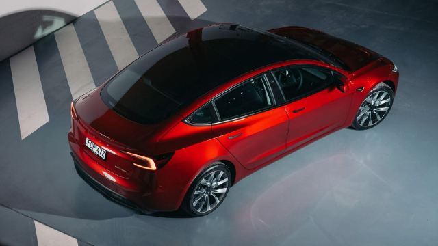 Overhead view of bright red Tesla.