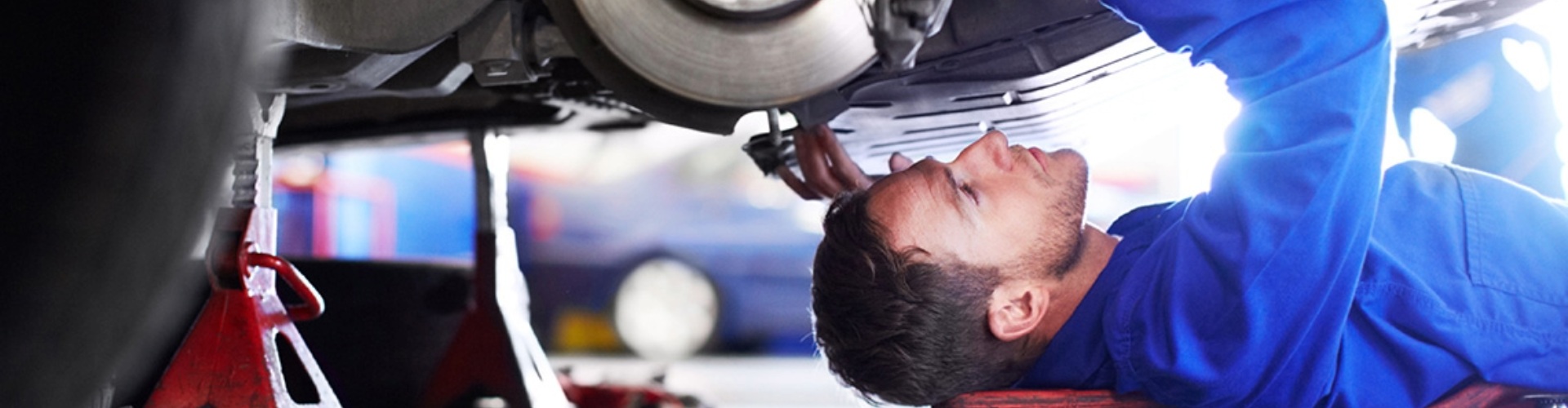 A mechanic working beneath a car
