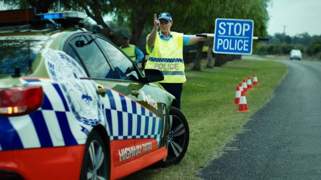 A police officer undertaking roadside random breath tests