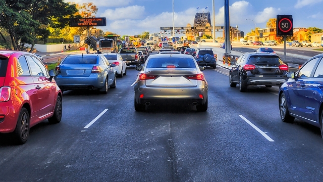 Rear view of traffic heading toward the Sydney Harbor Bridge.