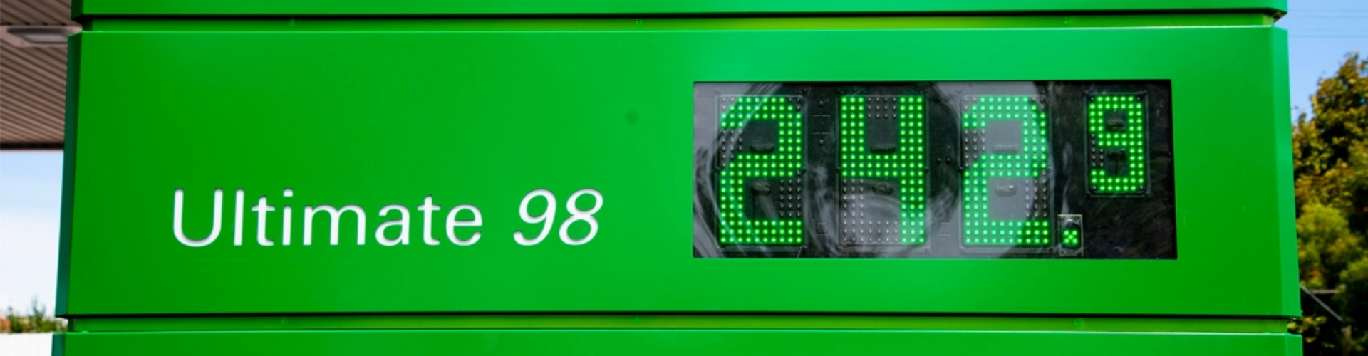 A green fuel price signage board displaying two record high fuel price amounts for Unleaded 91 and Ultimate 98.