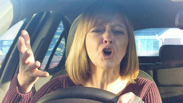 A driver at the wheel displaying symptoms of road rage