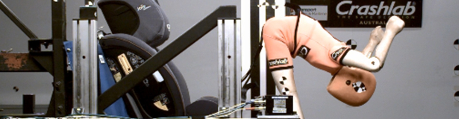 A child-sized crash test dummy being ejected from a child restraint seat