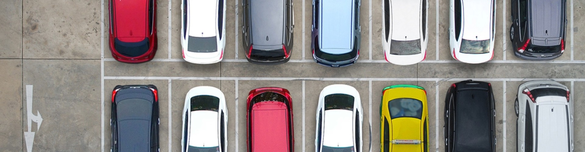 A carpark seen from over head, its spaces all filled