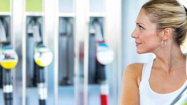 Woman looking at a fuel pump