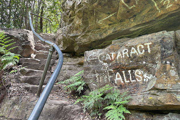 Hand-painted sign pointing to Cataract Falls in the Blue Mountains.