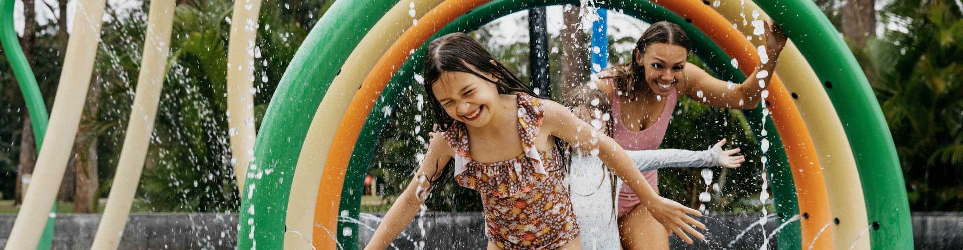 A family playing in the water park at NRMA Ocean Beach Holiday Resort in Umina