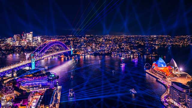Aerial view of Sydney Harbour at night including Opera House and Sydney Harbour Bridge