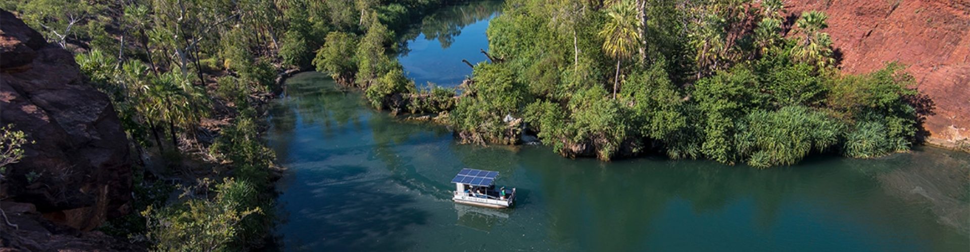 Adels Grove QLD ariel view of solar-powered boat on a river