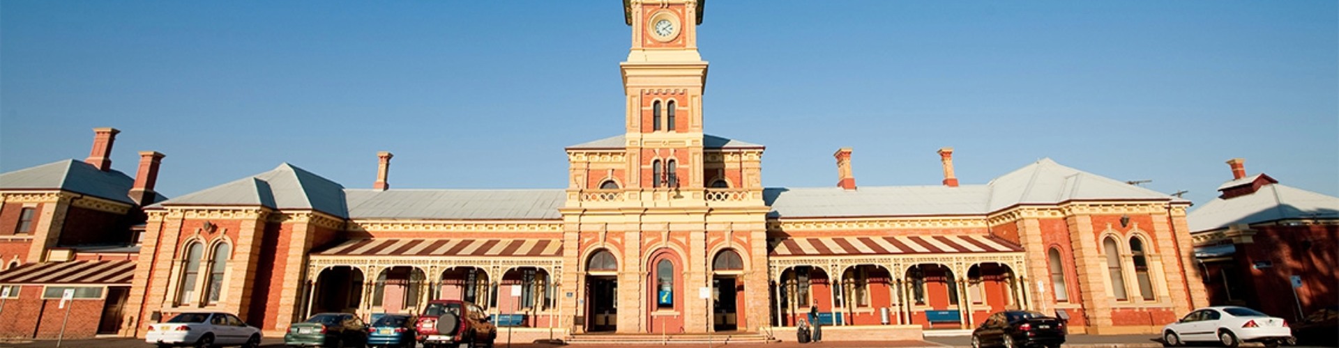 Albury railway station NSW view of the front of red brick and sandstone historic railway station with clock and bell tower