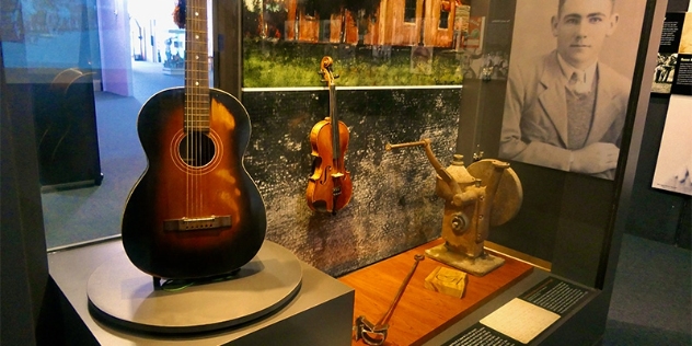 Exhibit with a guitar once owned by Slim Dusty