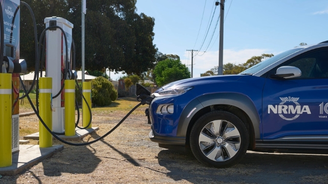 side view of a blue nrma electric vehicle charging at the nrma charging station in Wilcannia
