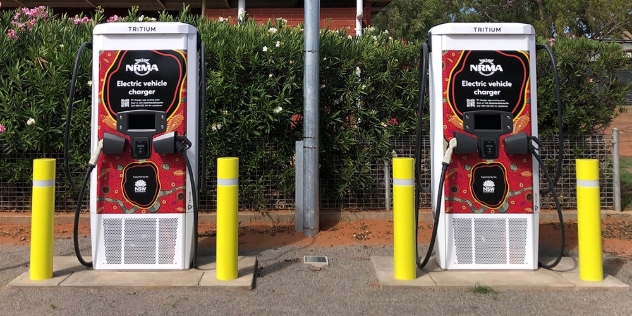 two NRMA electric vehicle charging stations decorated with red, yellow and black indigenous artwork 