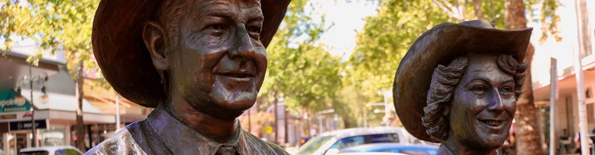 Slim Dusty and Joy McKean monument Tamworth NSW head and shoulders of life-size bronze monument of slim dusty and joy mckeen with cars and streetscape behind