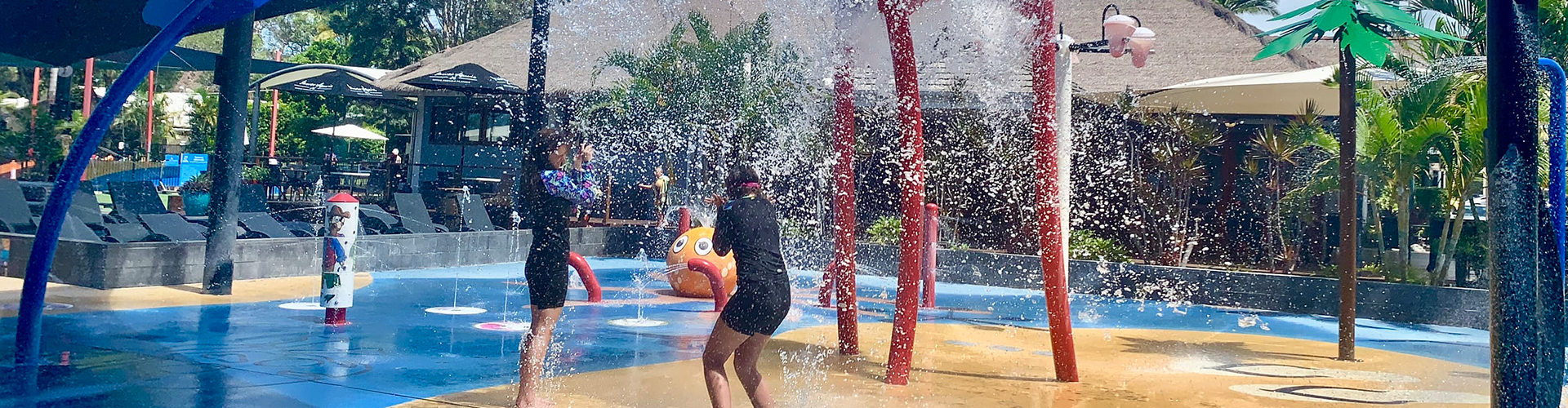 kids playing under the water on the splashpad