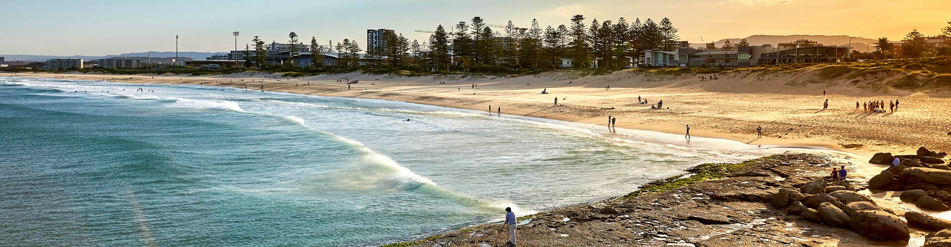 People enjoying the sand and surf at Main Beach, Wollongong.