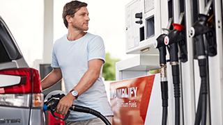 Man filling up car with fuel