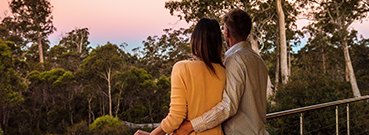 Couple watching sunset Cradle Mountain Hotel balcony