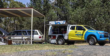 An NRMA truck parked in front of a vehicle in a parking space
